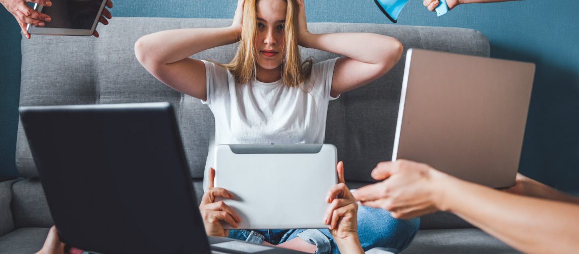 Informational digital detox. Fake news. A girl in stress and anxiety of depression closed her ears. He does not hear false information about the corona virus covid 19.