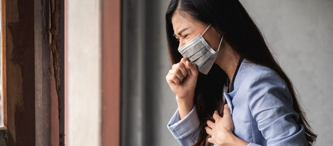 COVID-19 Pandemic Coronavirus, Asian woman wearing mask, have a symptoms coughing and fever