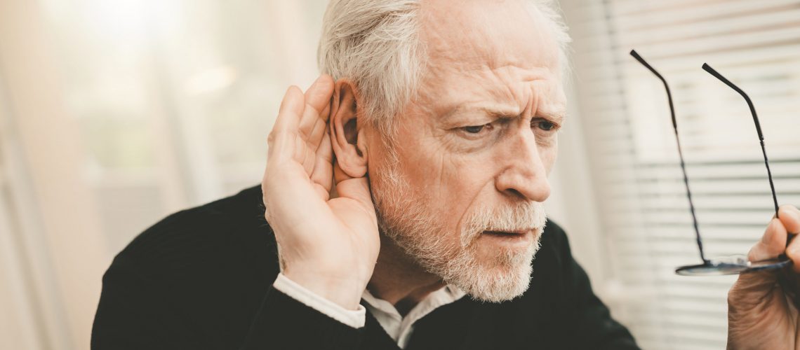 Portrait of senior man having hearing problems